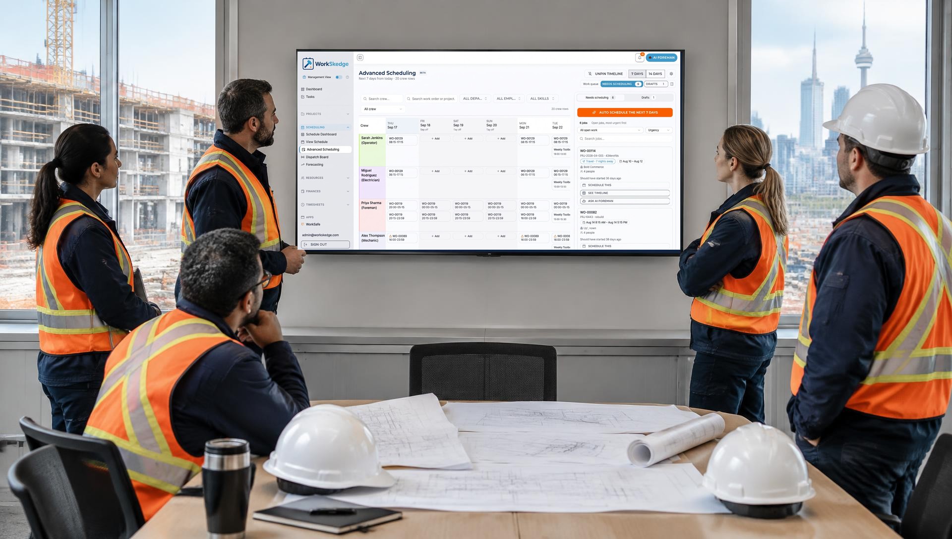 Construction operations team reviewing the WorkSkedge schedule in a site office